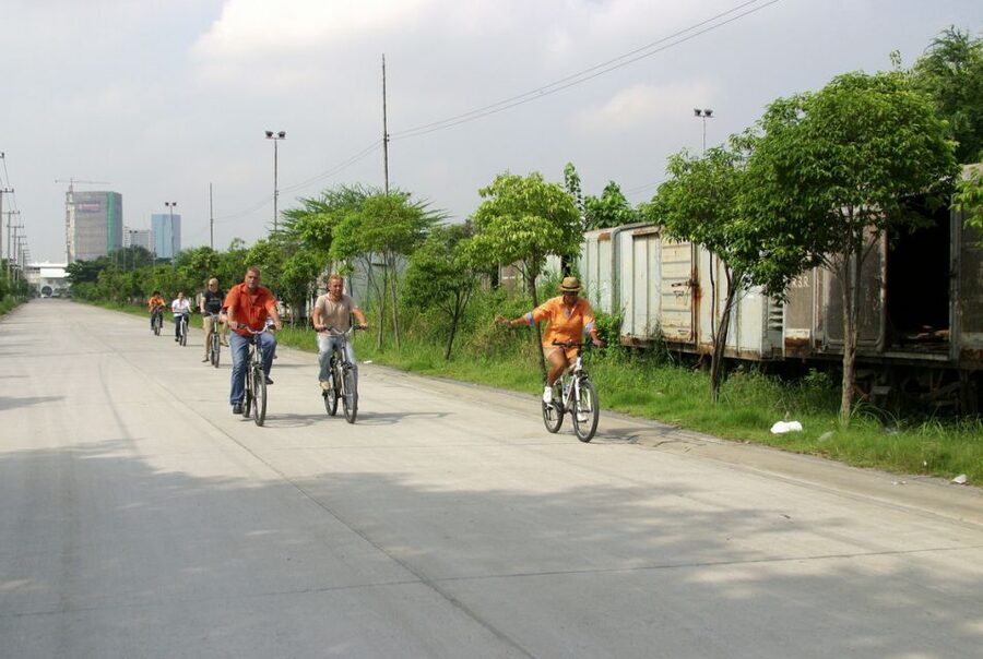 Bangkok: City Culture half-day Bike Tour - Crossing Rama IV Road and entering Benjakitti Forest Park
