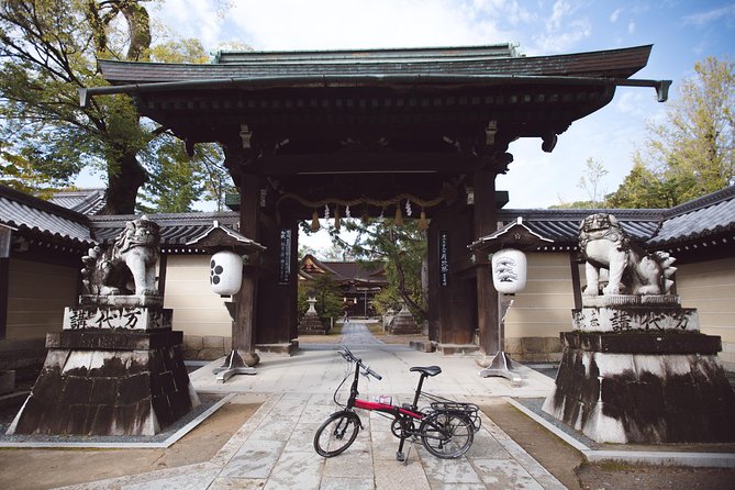An electric bike parked at a Kyoto temple gate