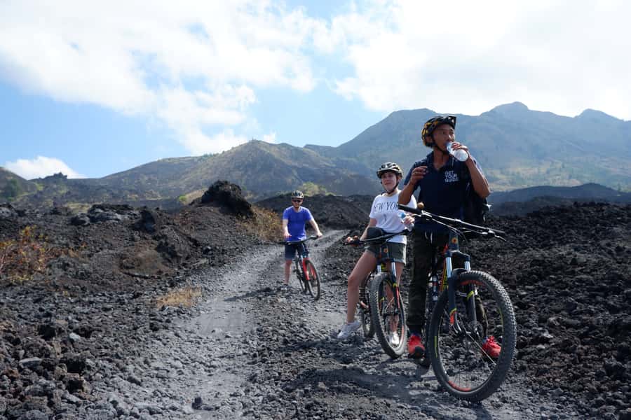 Mount Batur: Black Lava Cycling Tour w/ Natural Hot Spring - A temple, village roads, and views toward Lake Batur