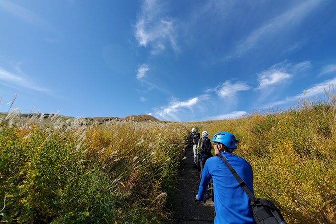 Private E-MTB guided cycling around Mt. Aso volcano & grasslands - The downhill return and wide caldera views