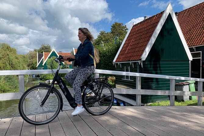 Visit Amsterdam Countryside with windmills by bike - Riding through wet meadows and old farm country